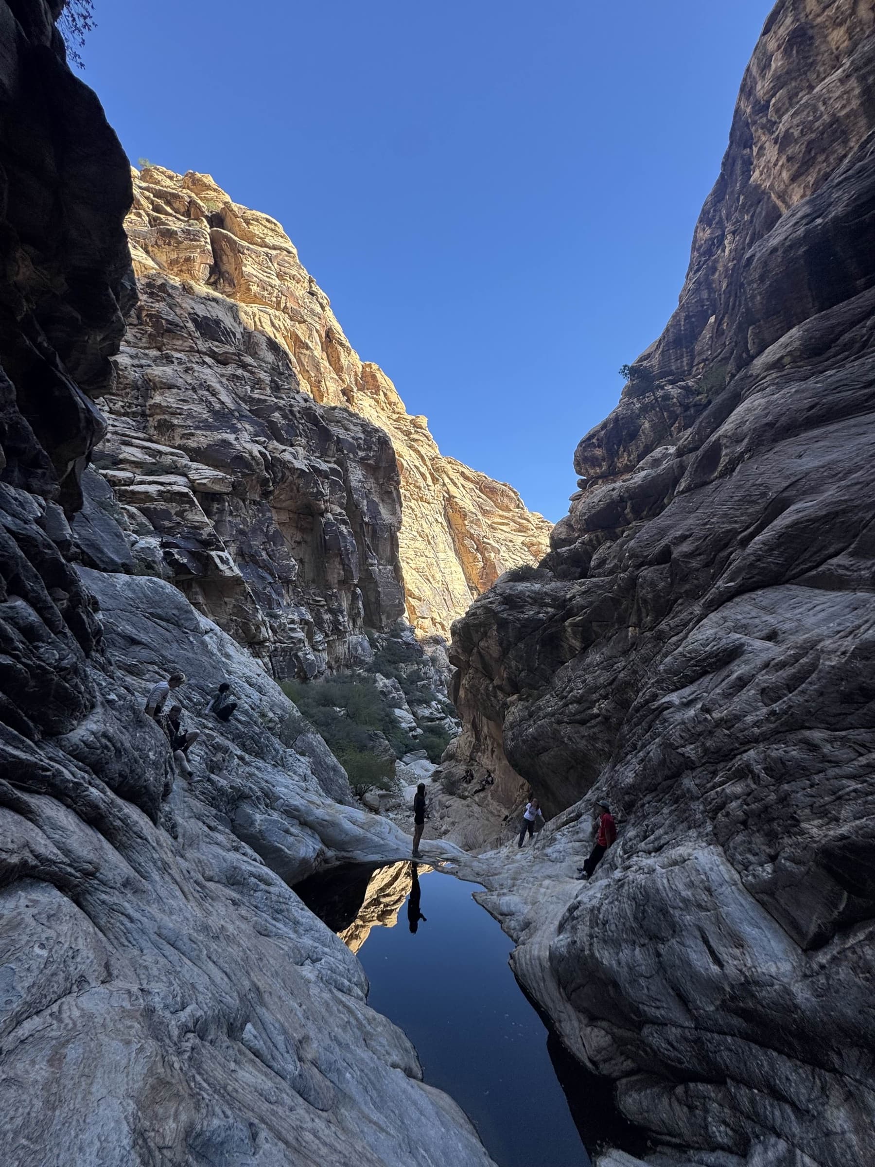 Mountain Club members exploring a rocky desert canyon